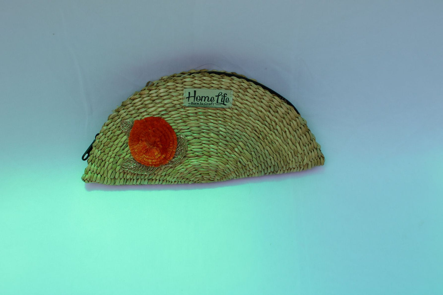 Handwoven clutch with flower appliqua